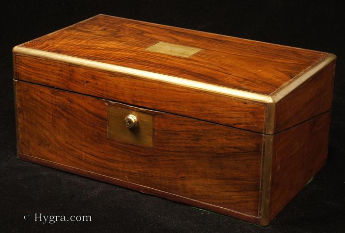 Writing box veneered in figured walnut, with rounded brass surround and brass lines. Strong Bramah lock. Enlarge Picture